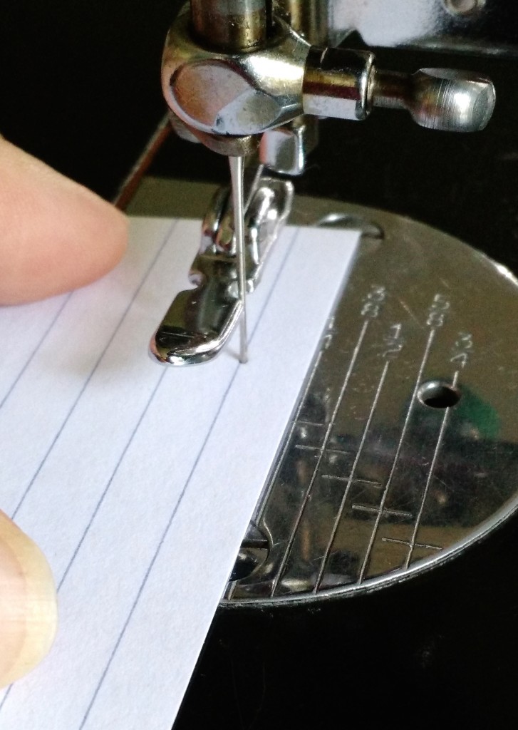 I have the foot raised and have carefully inserted the needle into the hole so I wouldn't tear it accidentally. I've also lined it up with the guides on the bed so it's nice and straight. This 1/4" is nice and accurate!